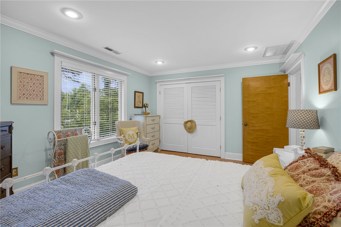 218 Northridge Drive Anderson, SC 29621 - Photo 30 of 50 Well-lit sleeping quarters with a window overlooking mature trees and crown molding details.