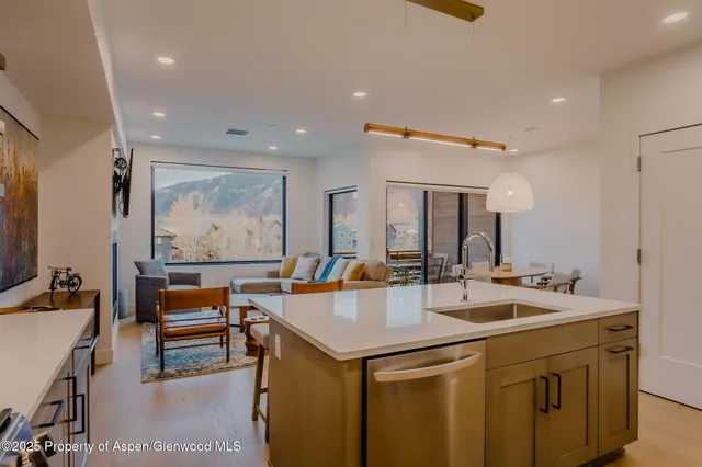 a living room with furniture and a painting on the wall