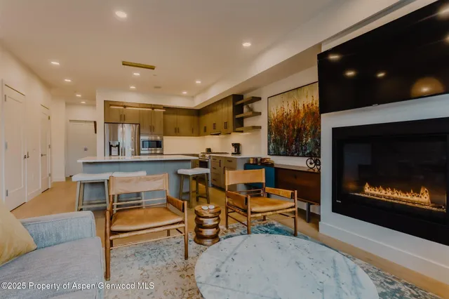 a living room with furniture and kitchen view