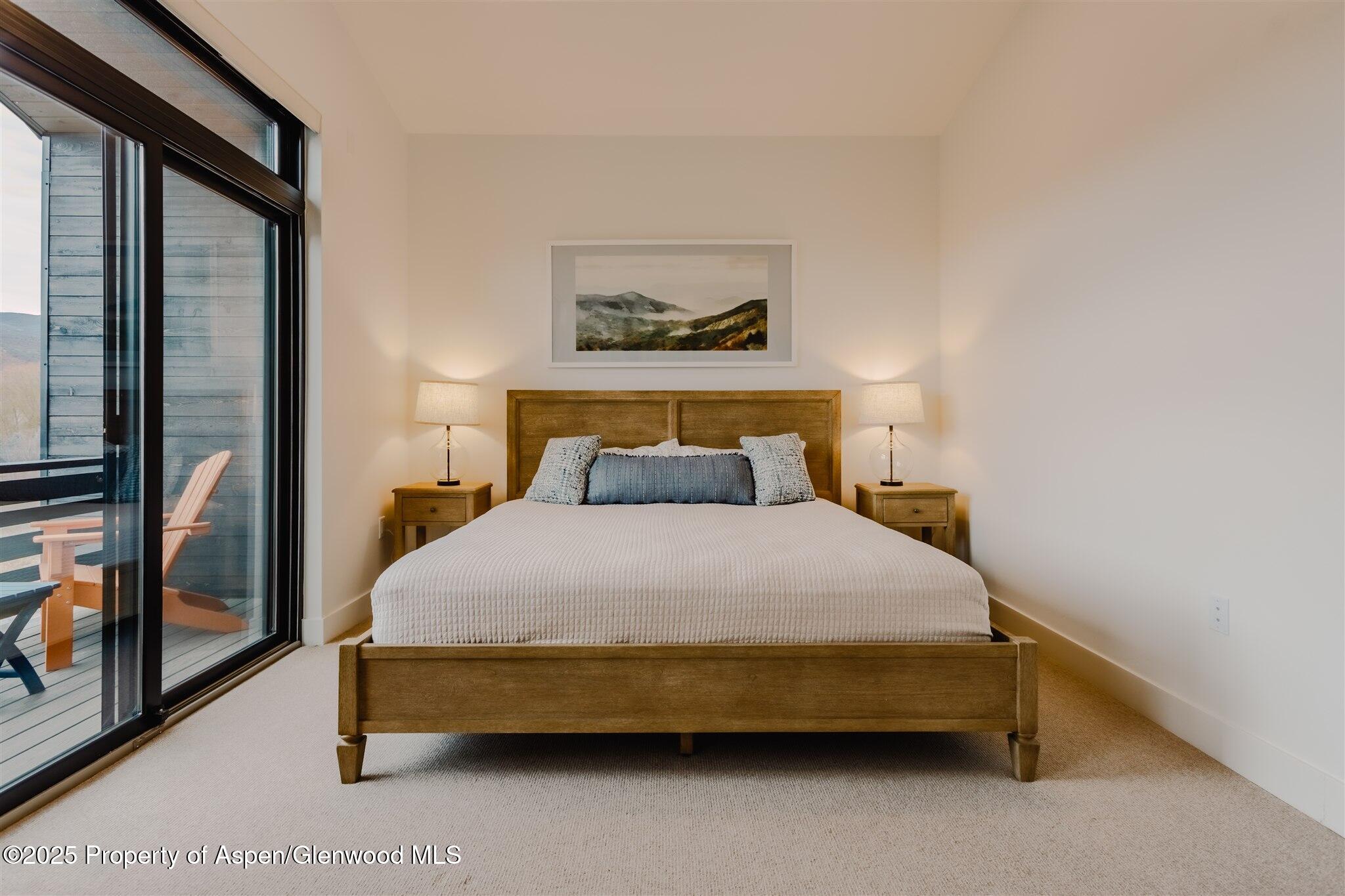 220 Lewis Lane Basalt, CO 81621 - Photo 25 of 62 a bedroom with a bed and a painting on the wall