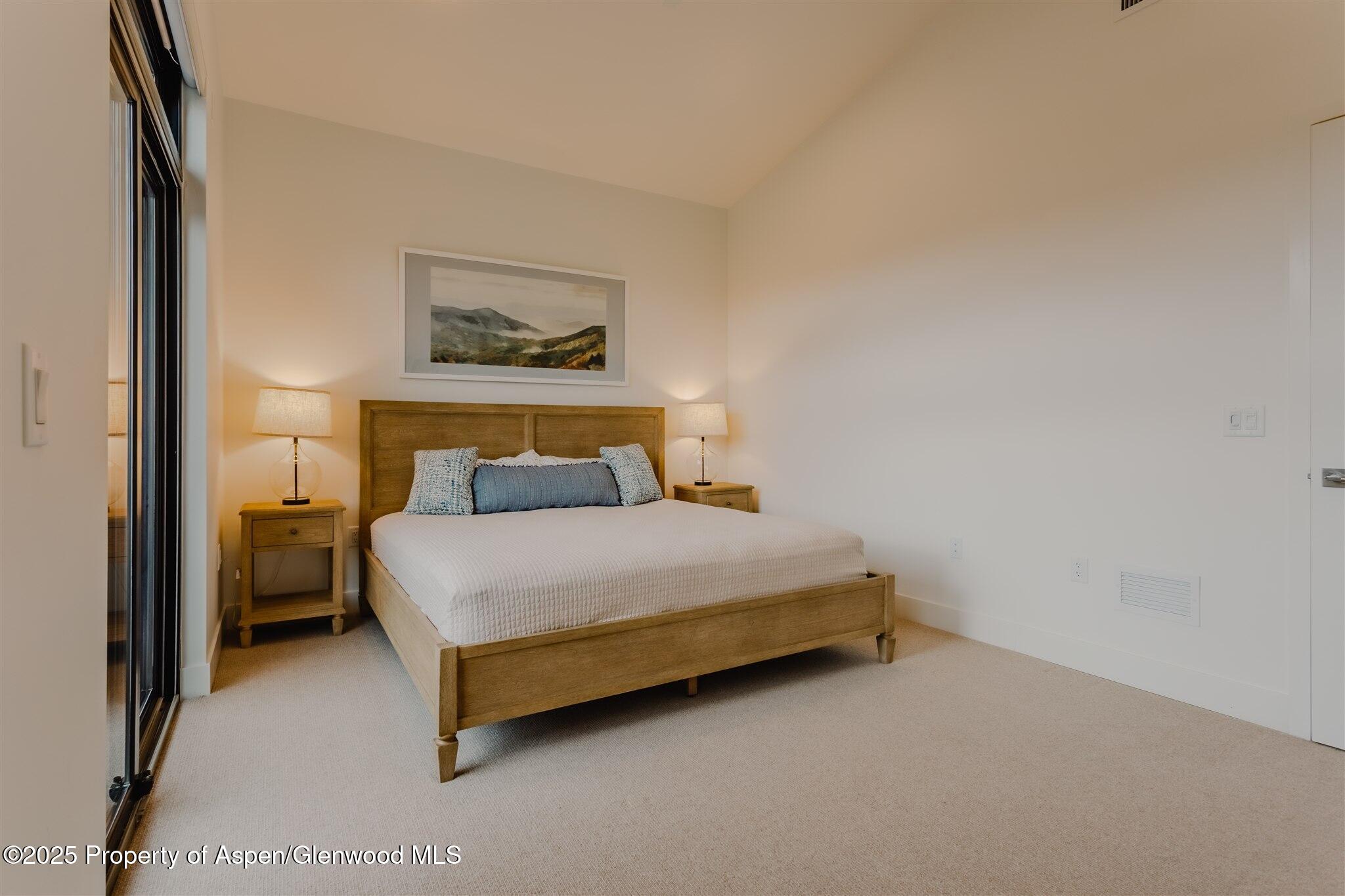 220 Lewis Lane Basalt, CO 81621 - Photo 26 of 62 a bedroom with a bed and a painting on the wall