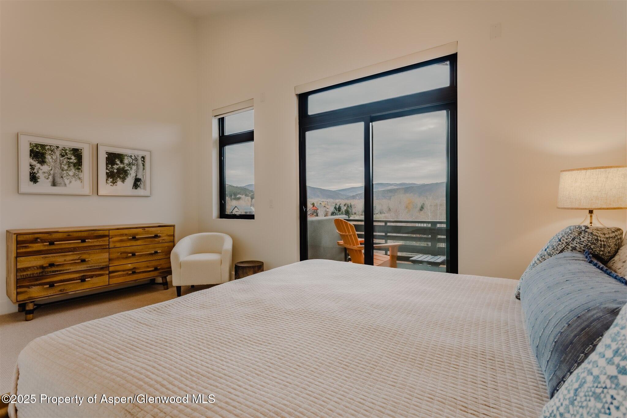 220 Lewis Lane Basalt, CO 81621 - Photo 27 of 62 a bedroom with a bed and a large window