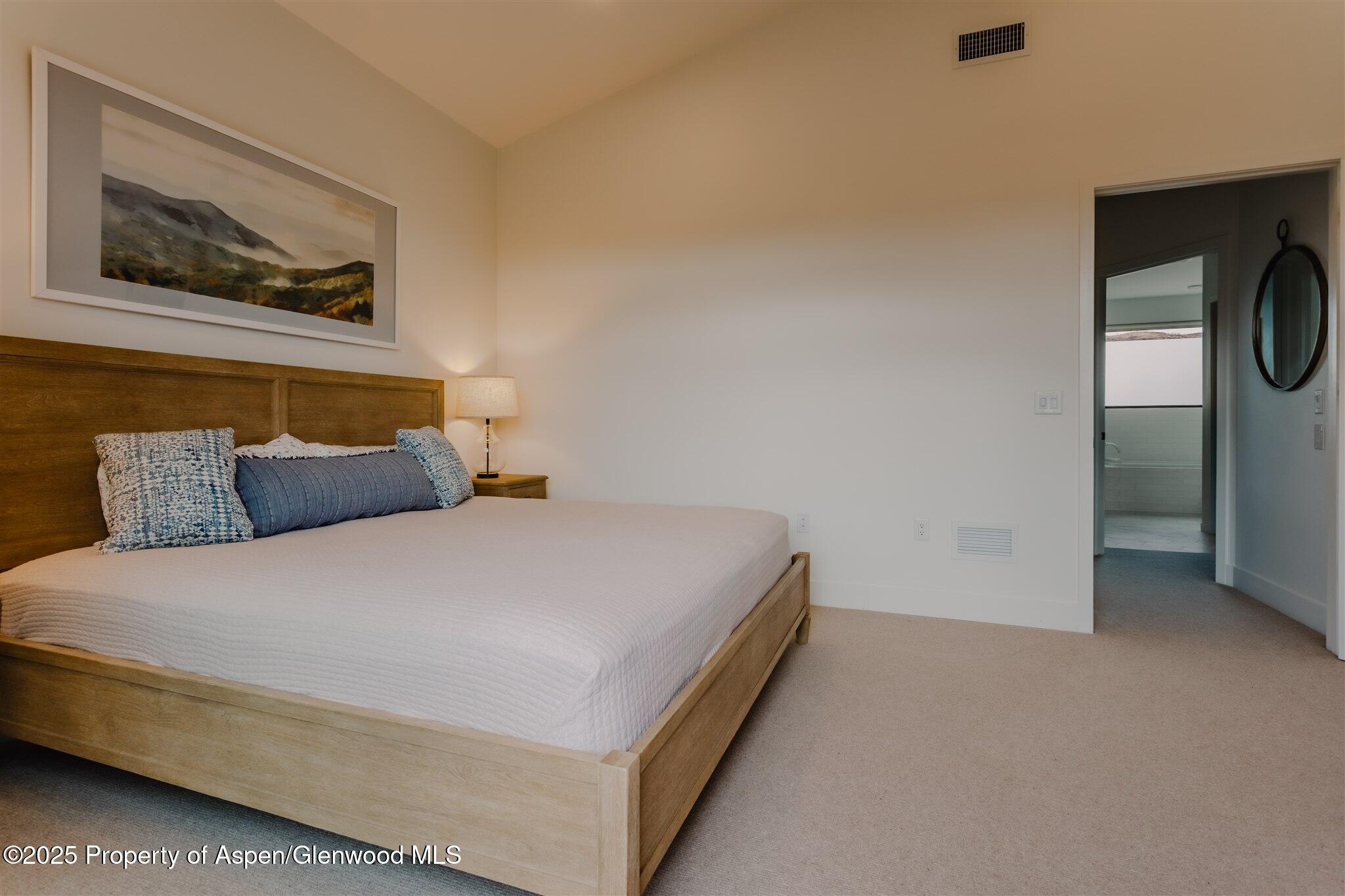 220 Lewis Lane Basalt, CO 81621 - Photo 28 of 62 a bed sitting in a bedroom next to a window