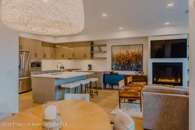 a open kitchen with stainless steel appliances granite countertop a stove and a refrigerator