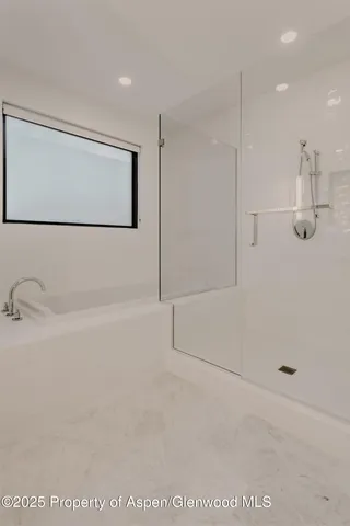 a bedroom with a large bed and a large window