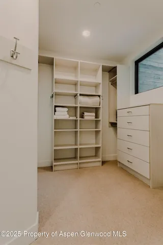 a bedroom with a large bed and a large window