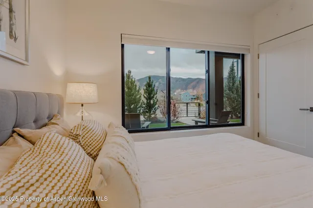 a bedroom with a bed and a painting on the wall