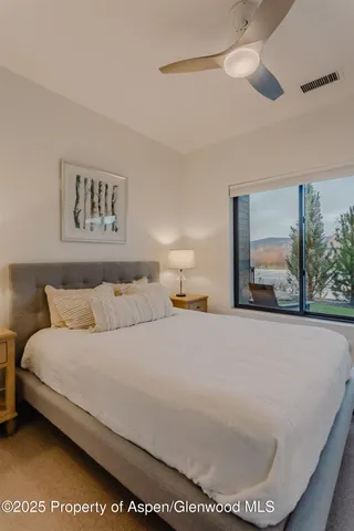 a bathroom with a toilet sink a mirror and vanity
