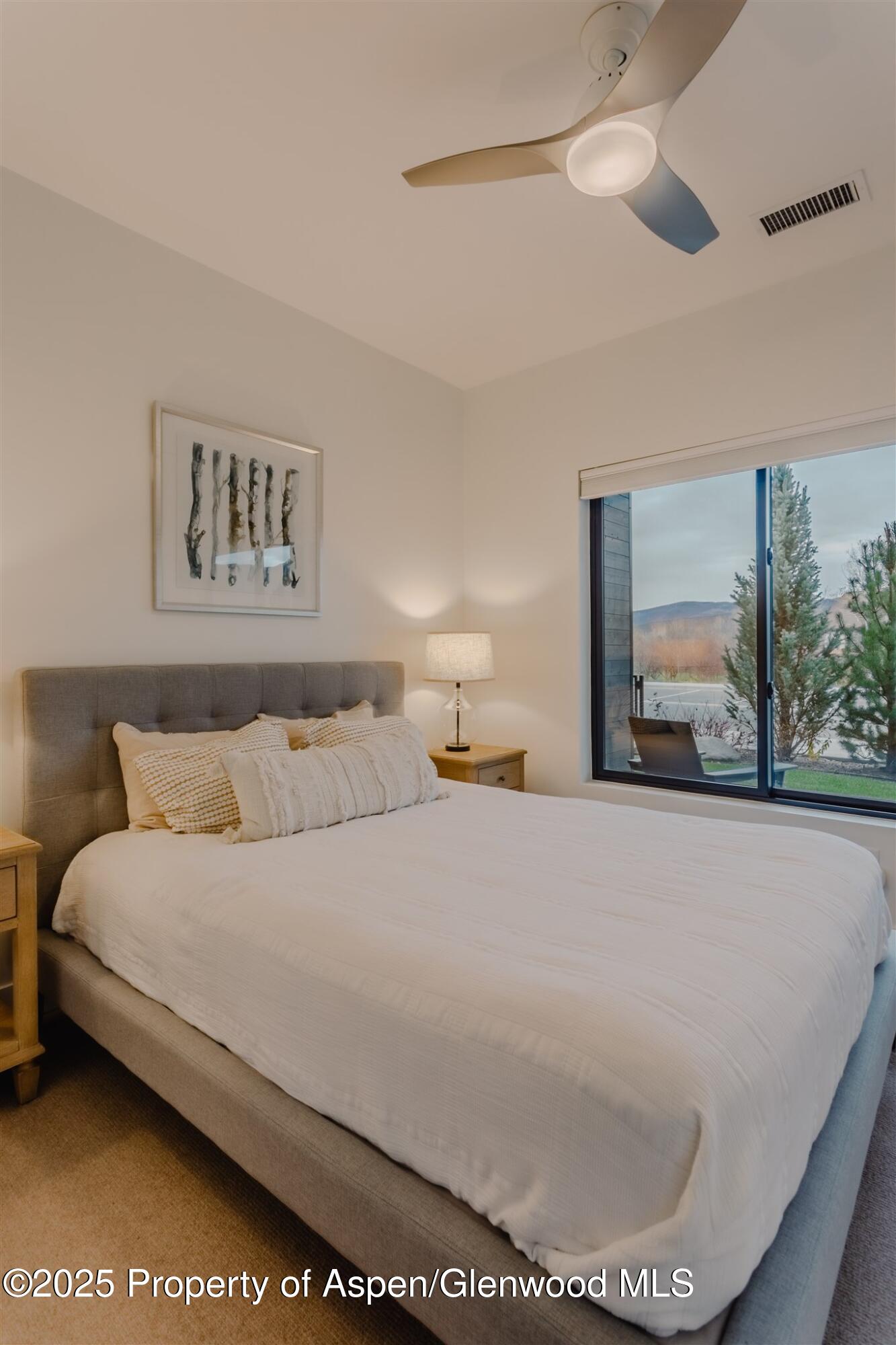 220 Lewis Lane Basalt, CO 81621 - Photo 44 of 62 a bedroom with a bed and a painting on the wall