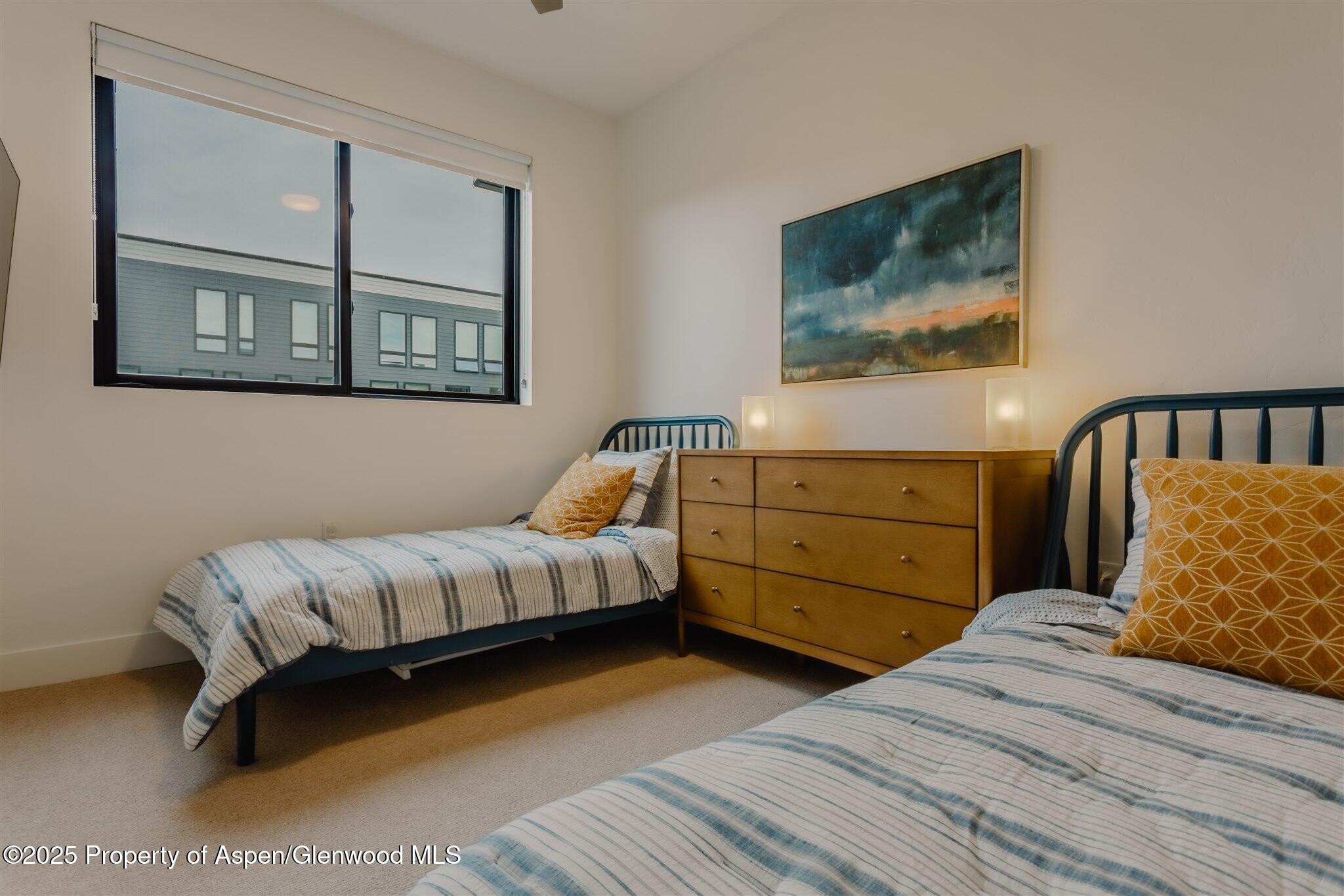 220 Lewis Lane Basalt, CO 81621 - Photo 48 of 62 a bedroom with a bed and a painting on the wall