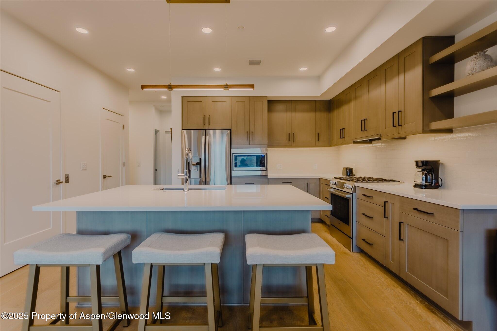 220 Lewis Lane Basalt, CO 81621 - Photo 5 of 62 a kitchen with stainless steel appliances granite countertop a table chairs sink and cabinets