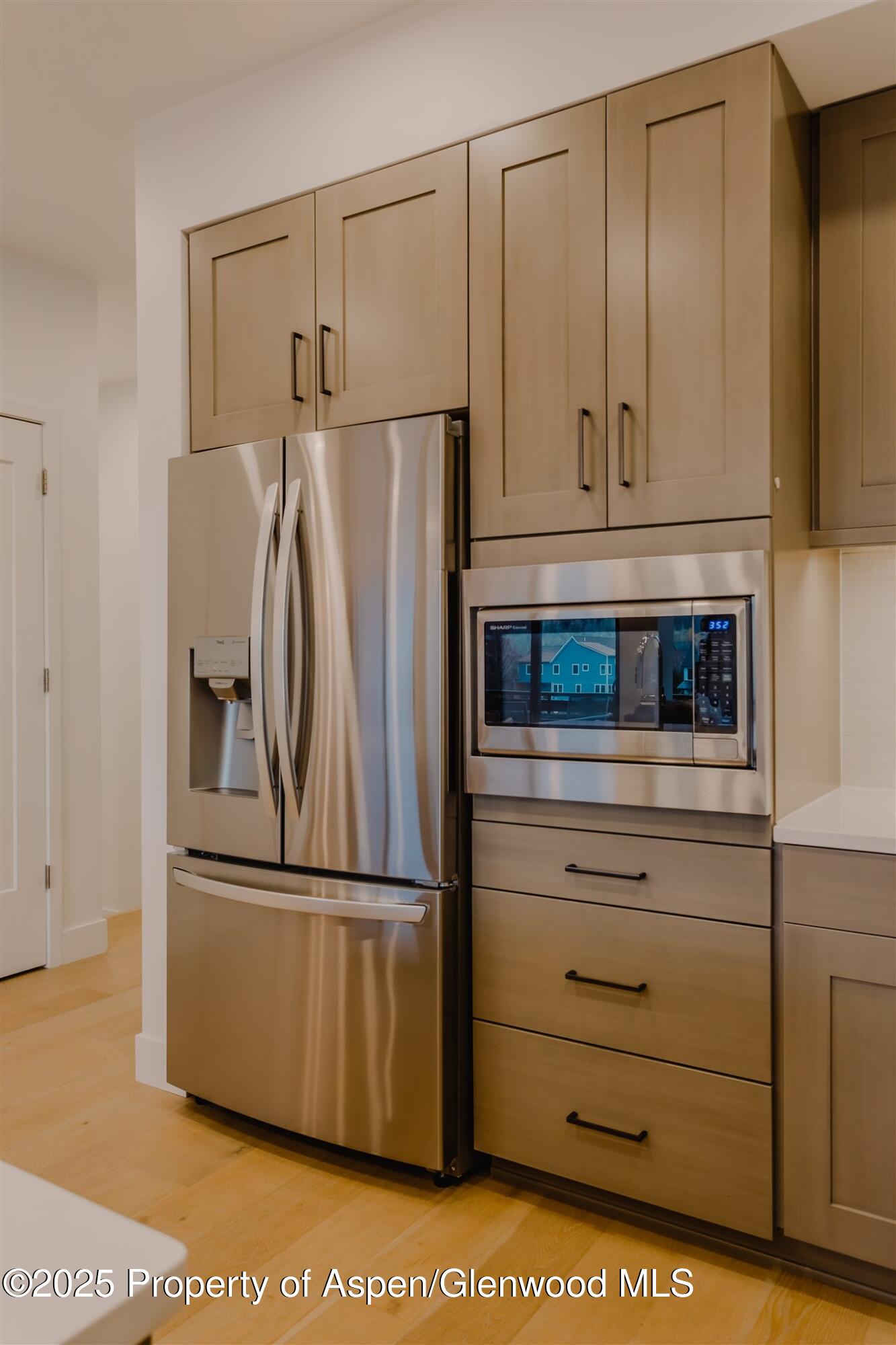 220 Lewis Lane Basalt, CO 81621 - Photo 8 of 62 a kitchen with appliances cabinets and a wooden floor