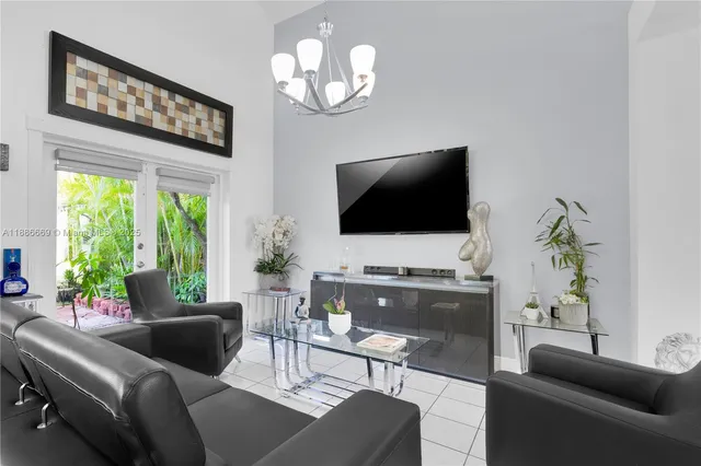 a living room with furniture a flat screen tv and a large window