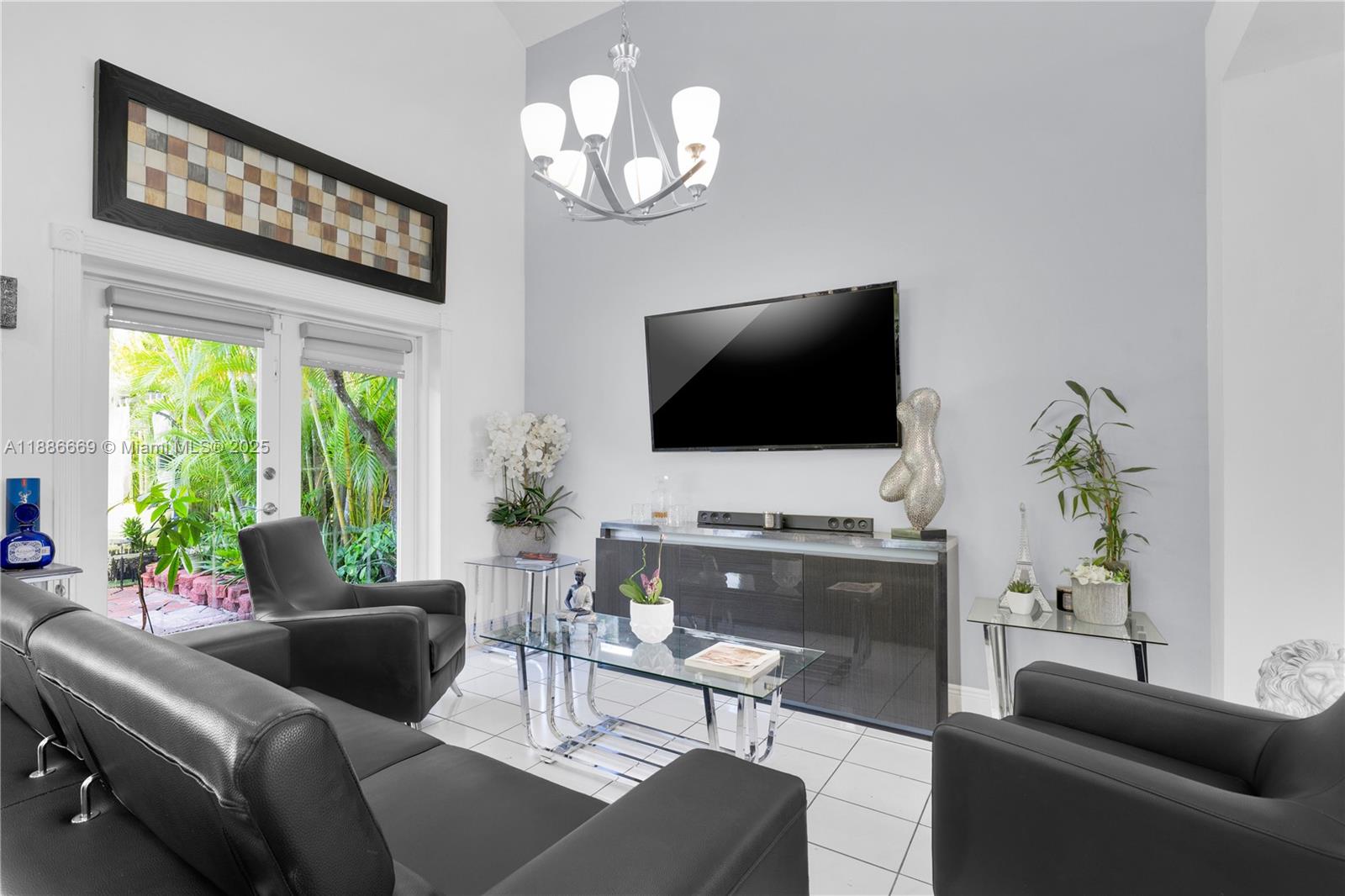 11126 Southwest 148th Place Miami, FL 33196 - Photo 12 of 33 a living room with furniture a flat screen tv and a large window