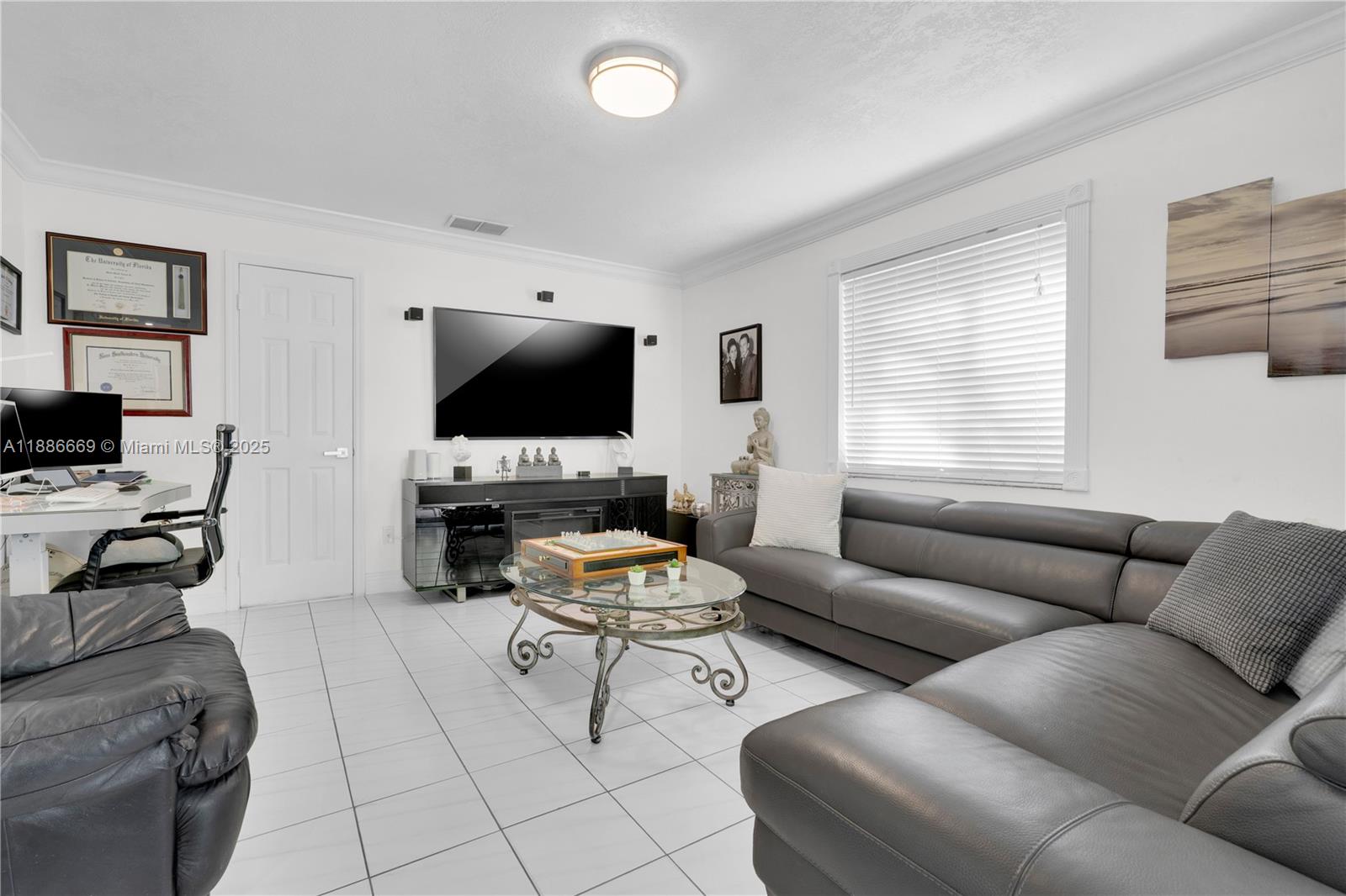 11126 Southwest 148th Place Miami, FL 33196 - Photo 13 of 33 a living room with furniture and a flat screen tv