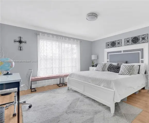 a spacious bedroom with a bed and a table