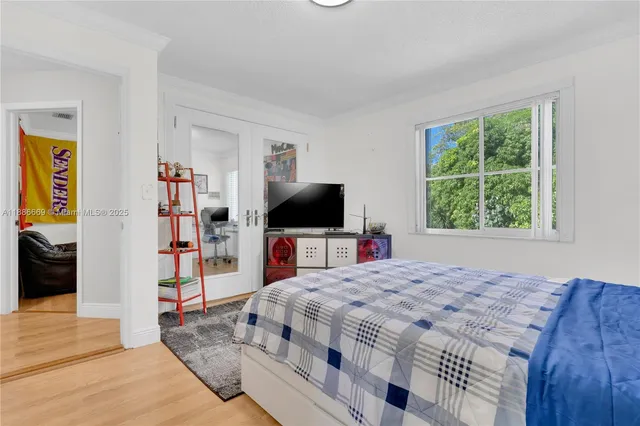 a bedroom with a bed and a flat tv screen