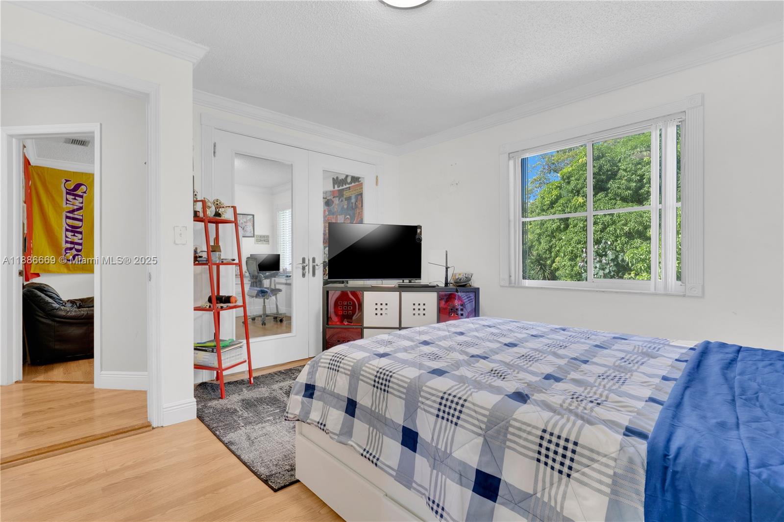 11126 Southwest 148th Place Miami, FL 33196 - Photo 21 of 33 a bedroom with a bed and a flat tv screen