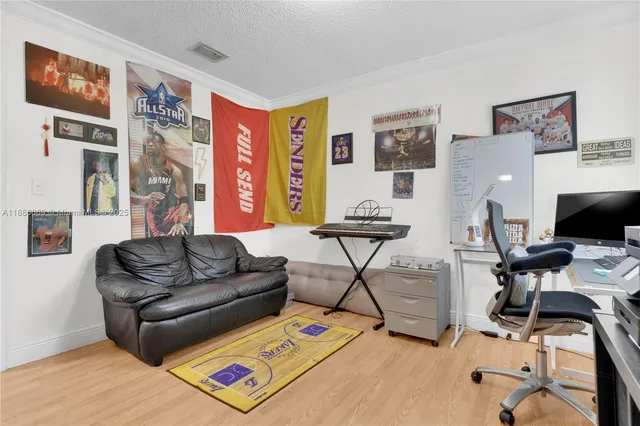 a living room with furniture and a flat screen tv with wooden floor