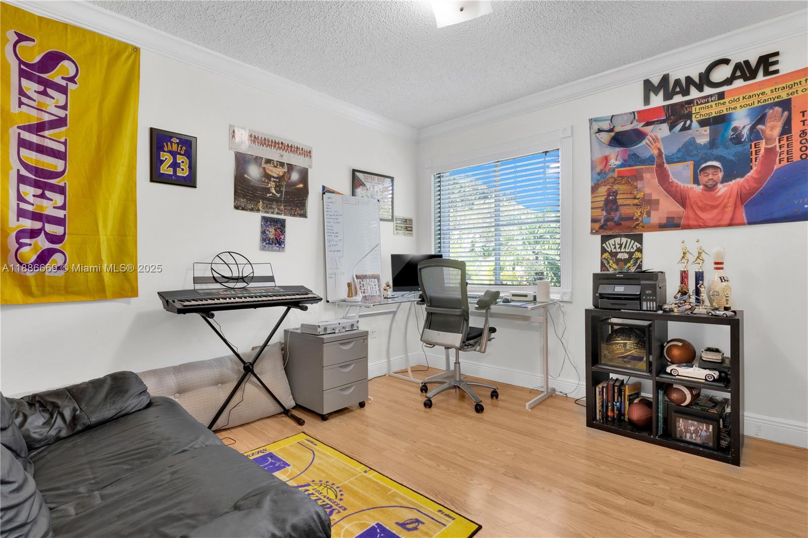 11126 Southwest 148th Place Miami, FL 33196 - Photo 23 of 33 a work room with furniture and wooden floor