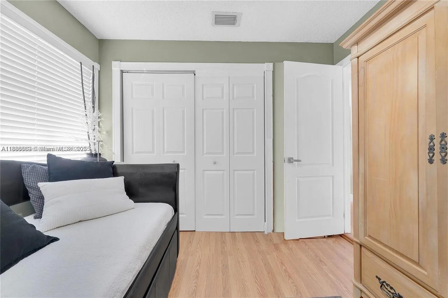 11126 Southwest 148th Place Miami, FL 33196 - Photo 24 of 33 a bedroom with a bed and a window