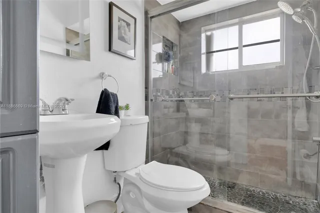 a bathroom with a sink toilet and shower