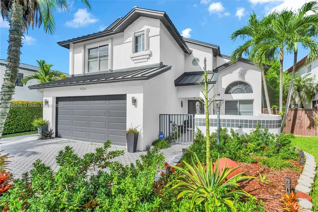 a front view of a house with a garden