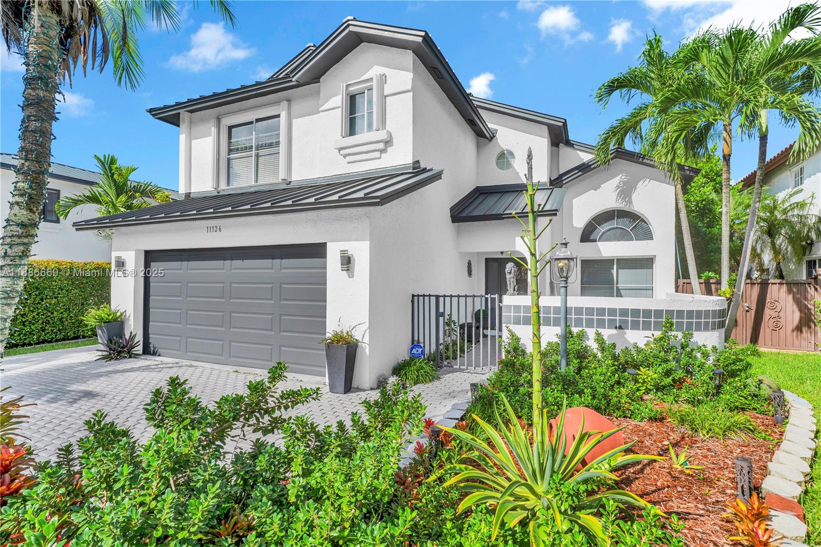11126 Southwest 148th Place Miami, FL 33196 - Photo 3 of 33 a front view of a house with a garden