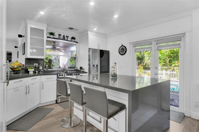 a kitchen with stainless steel appliances granite countertop a stove a sink and a refrigerator