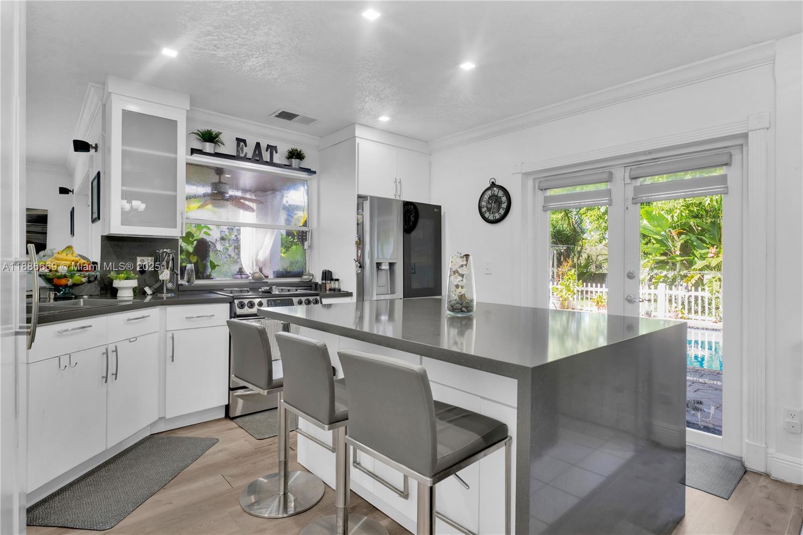 11126 Southwest 148th Place Miami, FL 33196 - Photo 9 of 33 a kitchen with stainless steel appliances granite countertop a stove a sink and a refrigerator