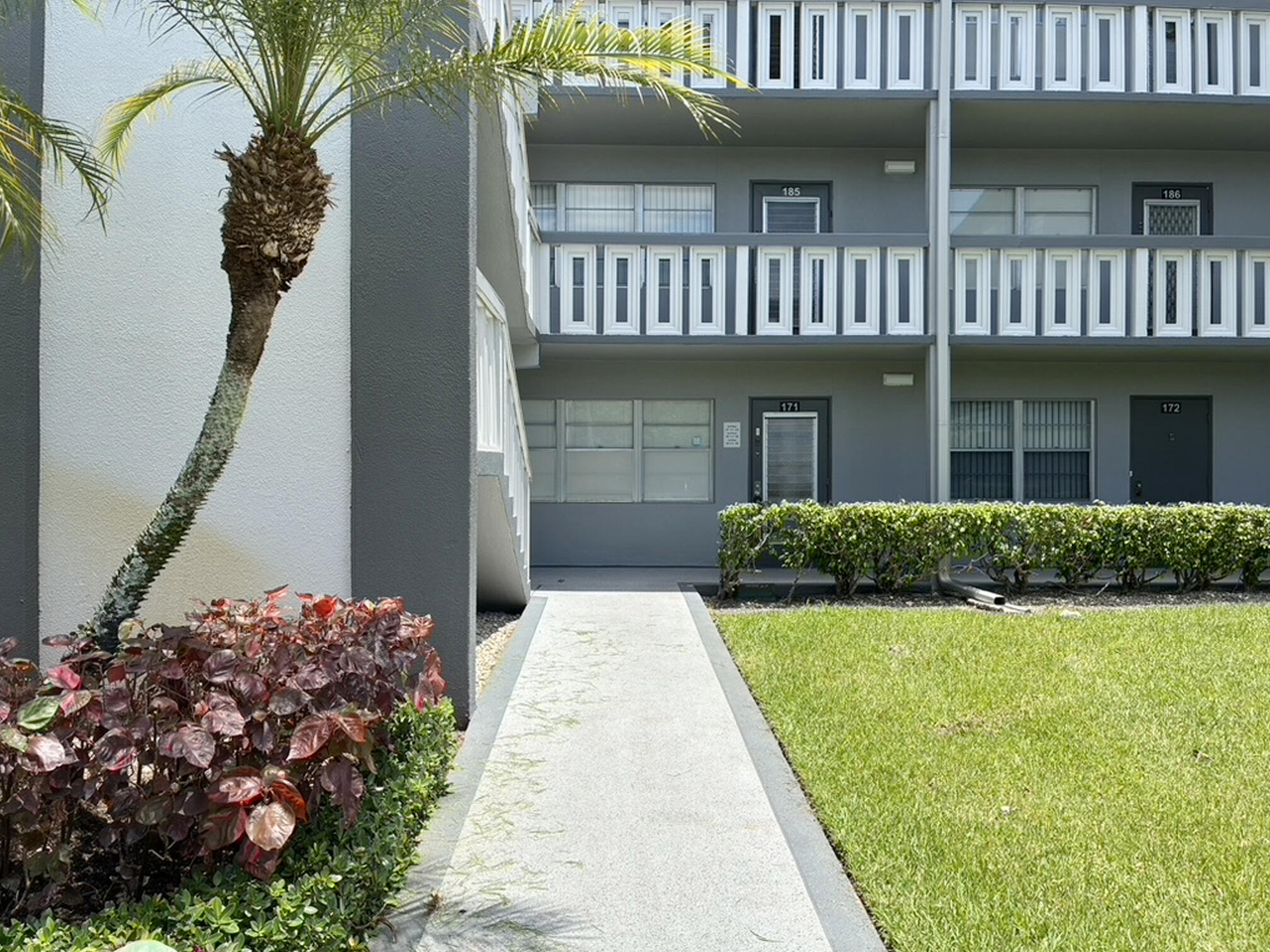 171 Suffolk F, Unit 171 Boca Raton, FL 33434 - Photo 2 of 21 a view of a house with a yard