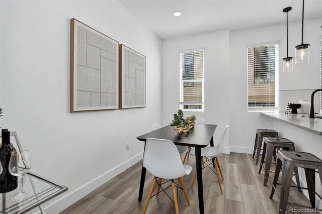 a dining room with furniture and wooden floor