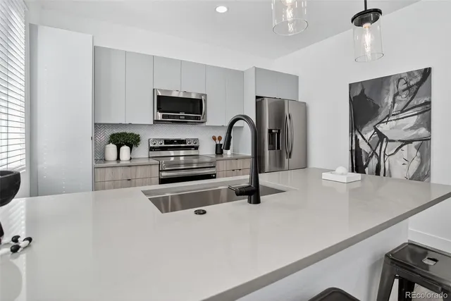 a kitchen with sink dining table and chairs