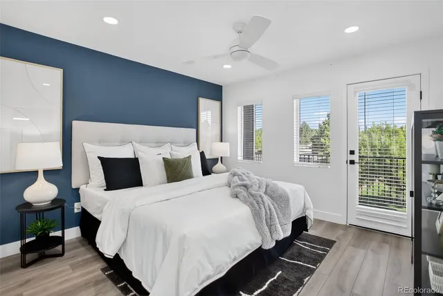 a bedroom with a large bed and a chandelier