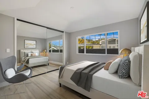 a bedroom with a bed and glass door