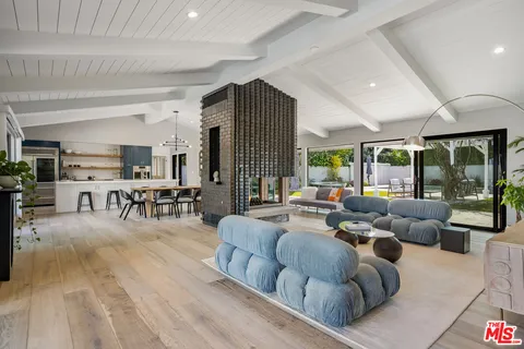 a kitchen with stainless steel appliances granite countertop a sink a stove and a refrigerator