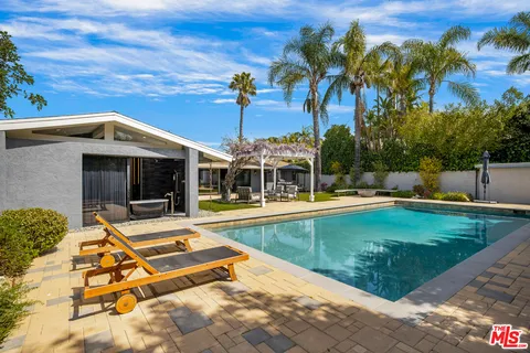 a view of a swimming pool with a patio