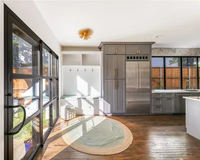 a kitchen with stainless steel appliances a refrigerator and a stove top oven