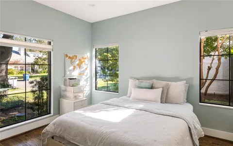 a bedroom with a large bed and a window