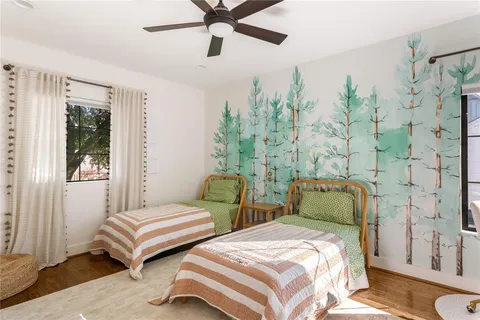 a bedroom with two beds and painted walls