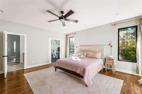 a bedroom with a large bed and a chandelier
