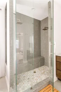 a bathroom with a shower and a sink