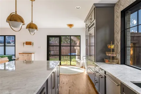 a kitchen with a sink and a large window