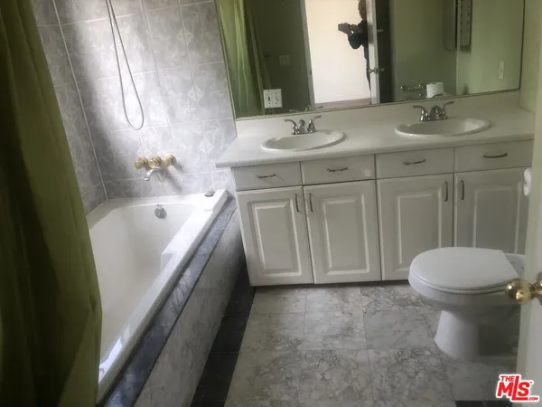 a bathroom with a sink a toilet and bathtub