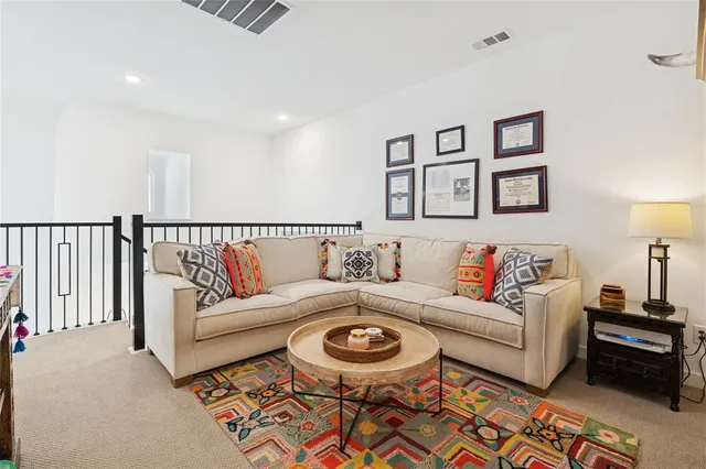 a living room with furniture and a rug