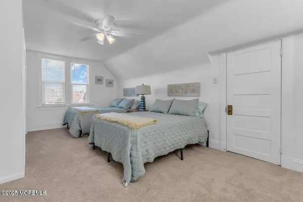 a bedroom with a bed and ceiling fan