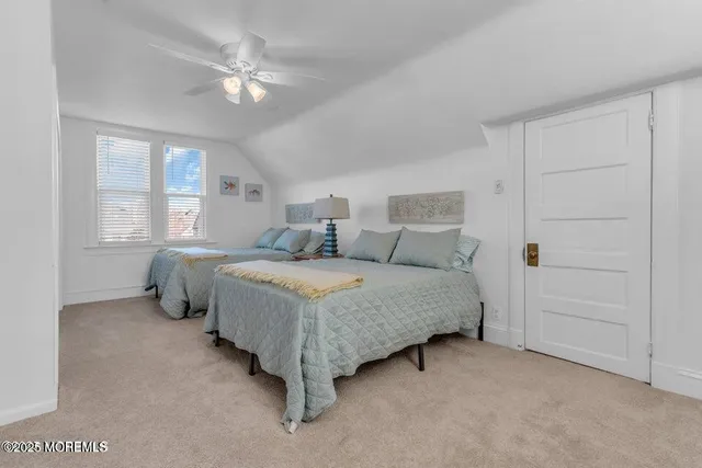 a bedroom with a bed and ceiling fan