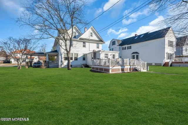 a view of a house with a backyard porch and sitting area