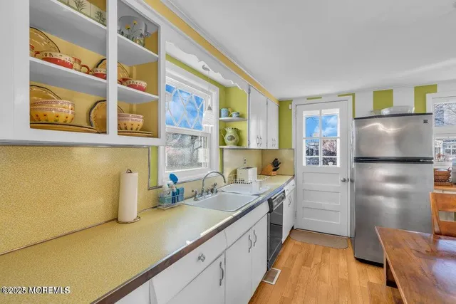 a kitchen with a refrigerator and a sink