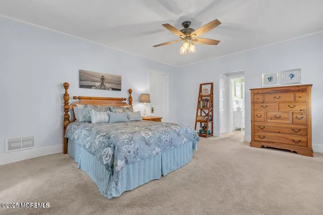 a bedroom with a bed and a ceiling fan